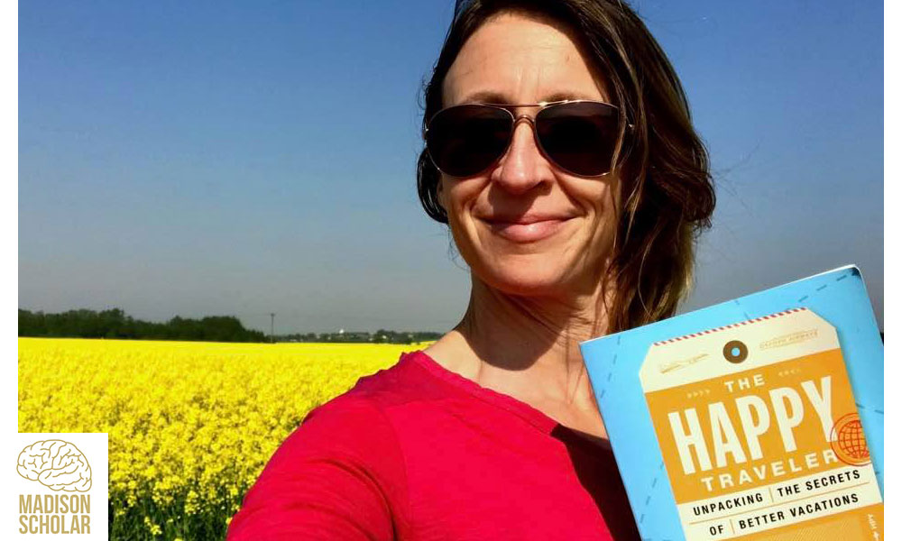 publicity photo of Kurtz holding her book with a field of yellow flowers and blue skies in the background