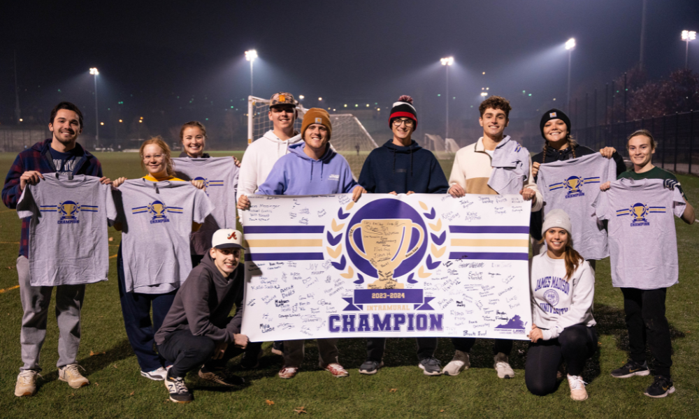 students holding up an intramural championship banner and celebrating